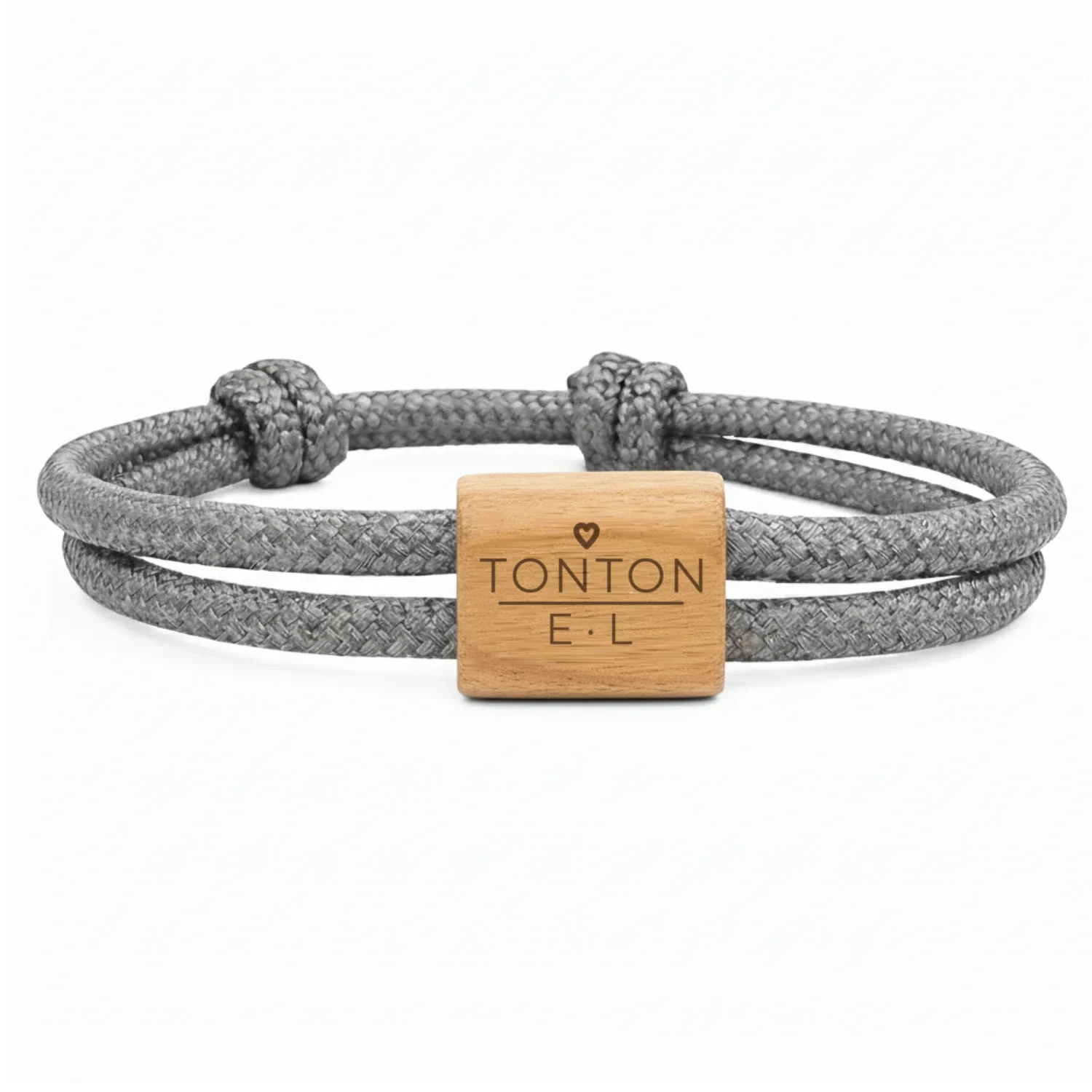 Photographie du bracelet PAPA, MAMAN, PAPI…, cordon gris anthracite : cordon marin double à nœuds coulissants et une plaque en bois de cerisier, gravée du mot PAPA et des initiales des enfants.